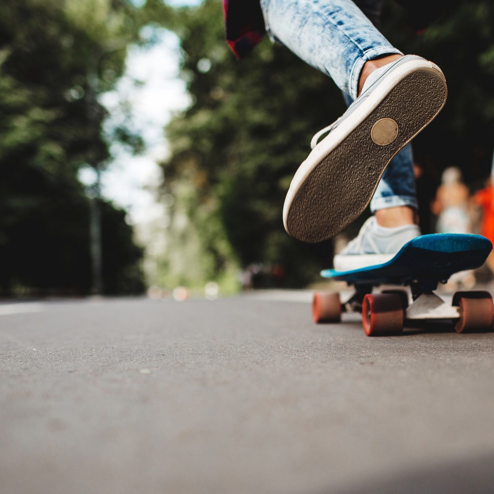 girl riding a skateboard in a city park